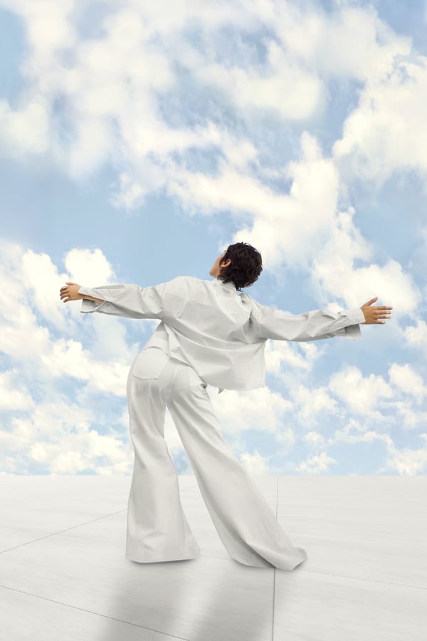 Pantone's Colour of the Year Cloud Dancer dancing amongst clouds.