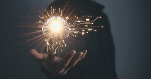 A hand holding a depiction of a brain diagram with lots of synapses to symbolise AI