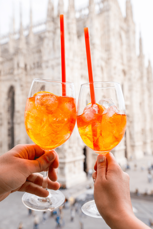 A couple enjoying an Aperol spritz in Italy.