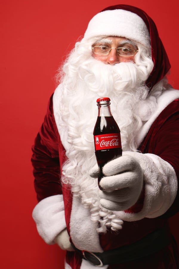 Santa holding a Coca-Cola.