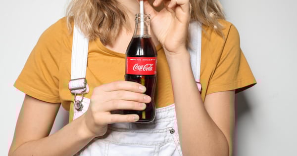 A girl drinking coca-cola.