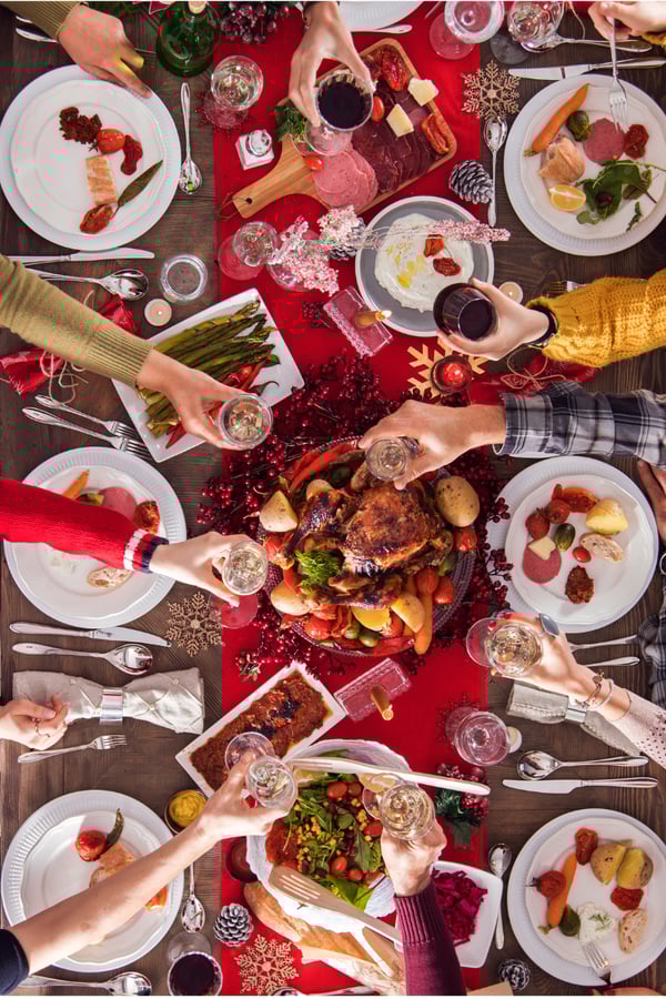 A photo of a Christmas meal from overhead with all the trimmings and turkey.
