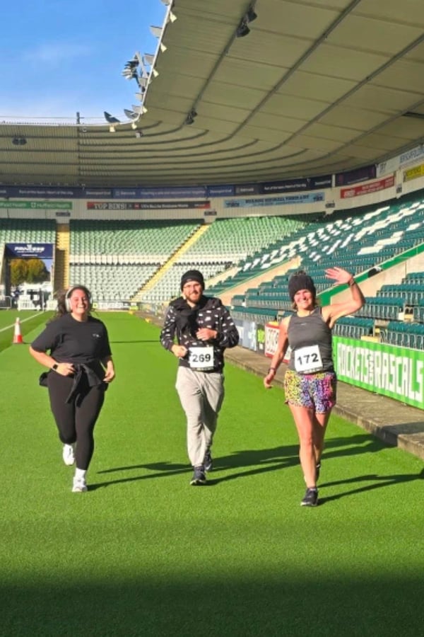 Kate, Hollie and Roy participating in the 2025 Plymouth Argyle Green Army Fun Run
