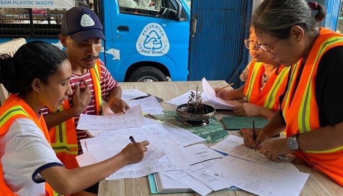 Employees at Prevented Ocean Plastic making sure all the recycled plastic is traceable.