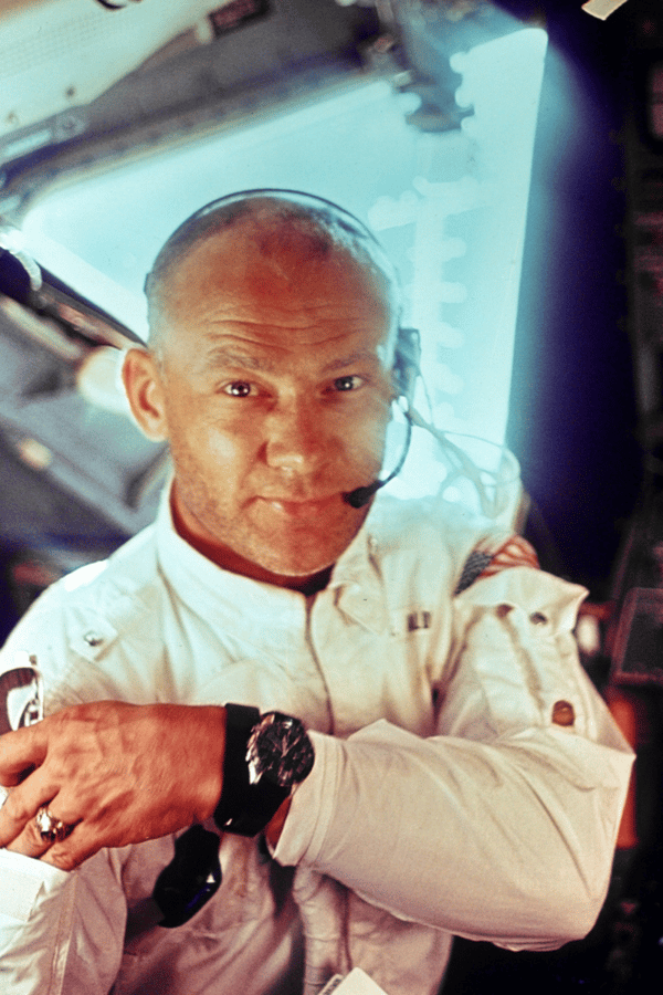 Buzz Aldrin sitting in a space ship. 