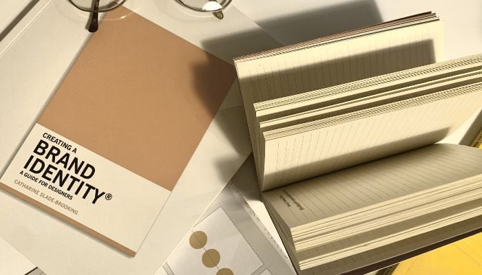 An image of a notebook and book showing brand identity. 