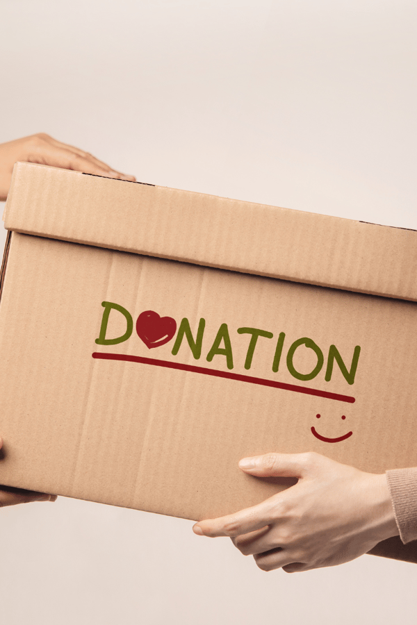 a cardboard box with the words 'donation' written on it with a smiley face. 