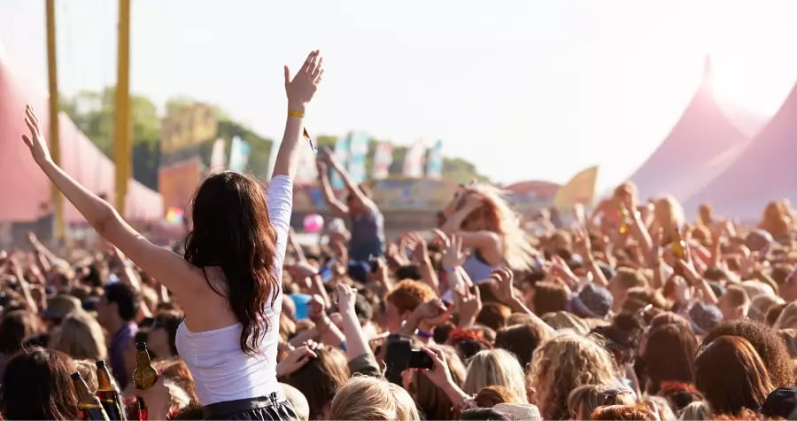 A crowd of people at a summer festival 
