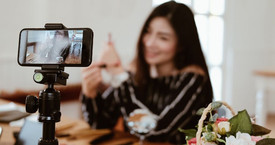 A social media influencer filming some trending content for TikTok