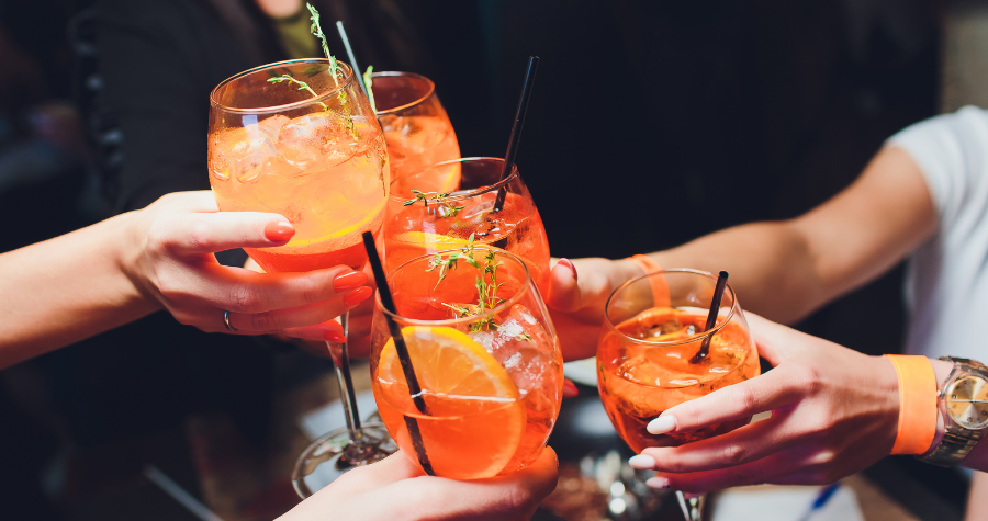 A group of people enjoying Aperol spritz' together 
