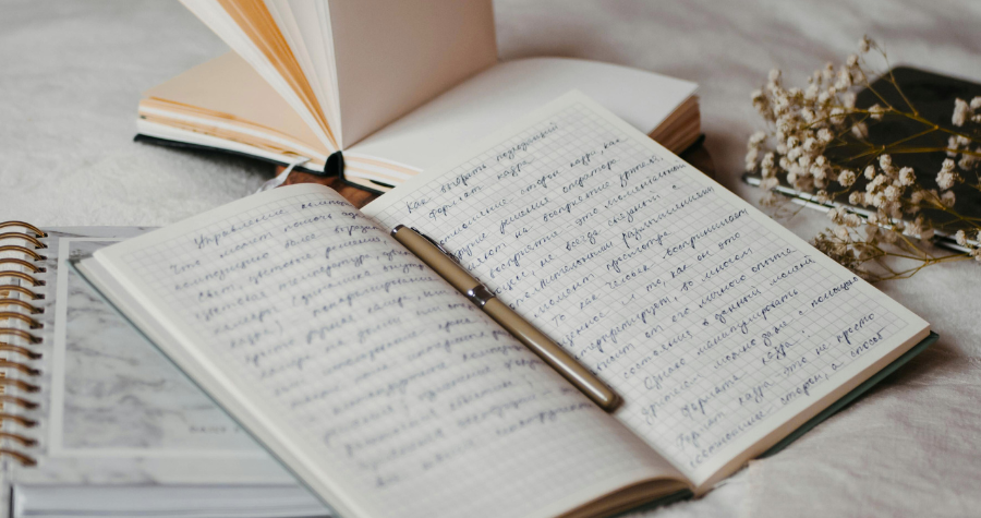 A notebook open on a table to show how useful branded promotional notebooks can be.